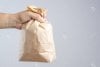 83769248-hand-holding-crumble-brown-paper-bag-panic-as-a-tool-for-relieving-panic-attack-or-be...jpg