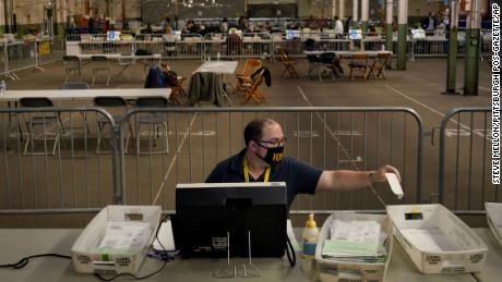 Members of the Allegheny County Return Board process the remaining absentee and mail-in Allegheny County ballots, Thursday, Nov. 12, 2020, on the North Side in Pittsburgh. (Steve Mellon/Pittsburgh Post-Gazette via AP)