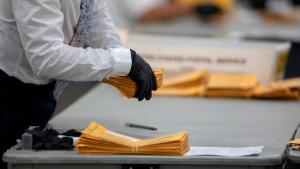 DETROIT, MI - NOVEMBER 04: A worker with the Detroit Department of Elections helps sort through absentee ballots at the Central Counting Board in the TCF Center on November 4, 2020 in Detroit, Michigan. President Trump narrowly won Michigan in 2016, and both he and Joe Biden campaigned heavily in the battleground state in 2020. (Photo by Elaine Cromie/Getty Images)